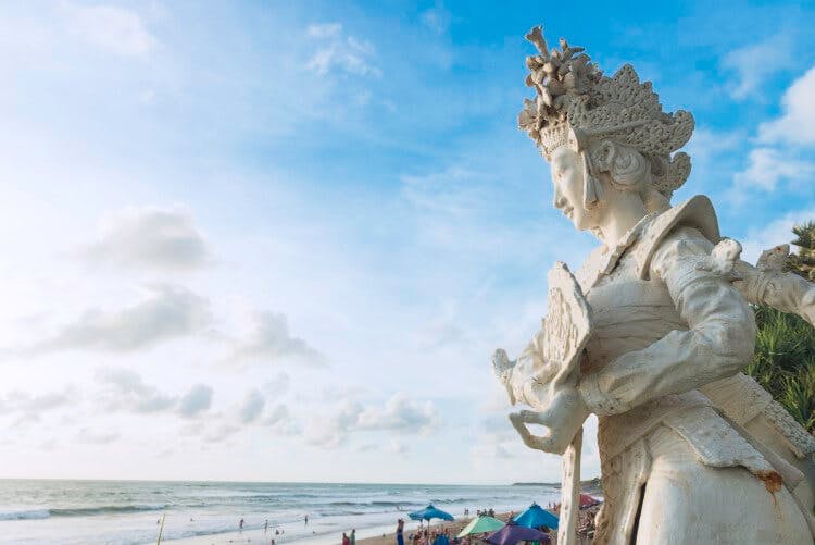 Image of a traditional temple statue by the sea in Bali