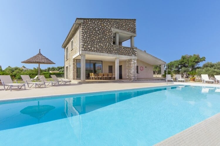 stone and white villa with pool