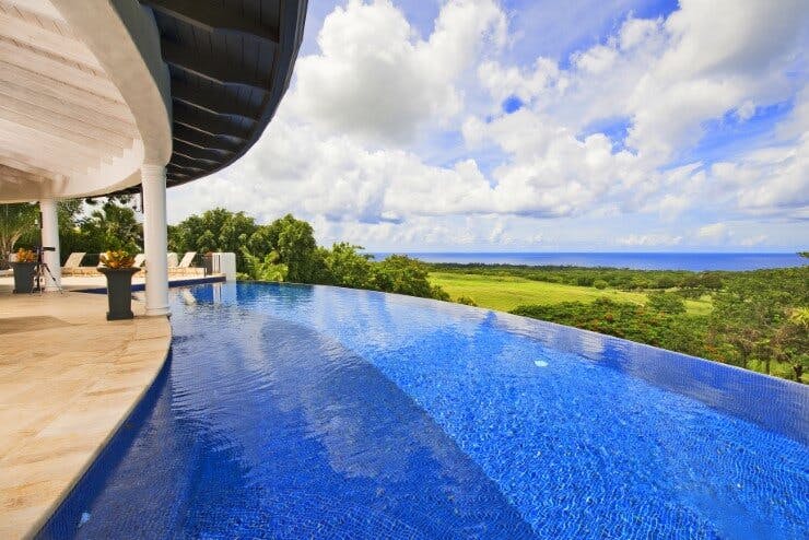 curved infinity pool with view out towards ocean
