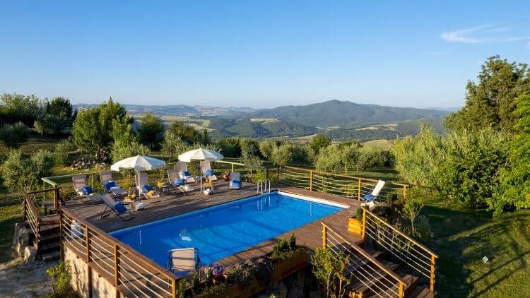 pool on elevated deck with view of countryside