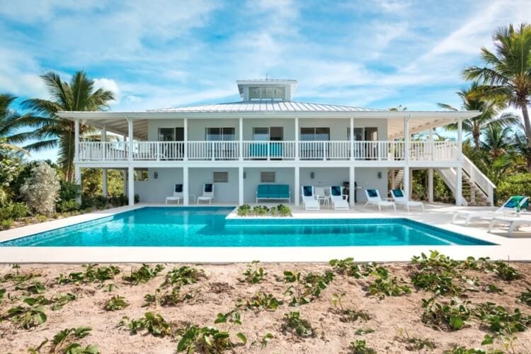 white villa with pool on the beach