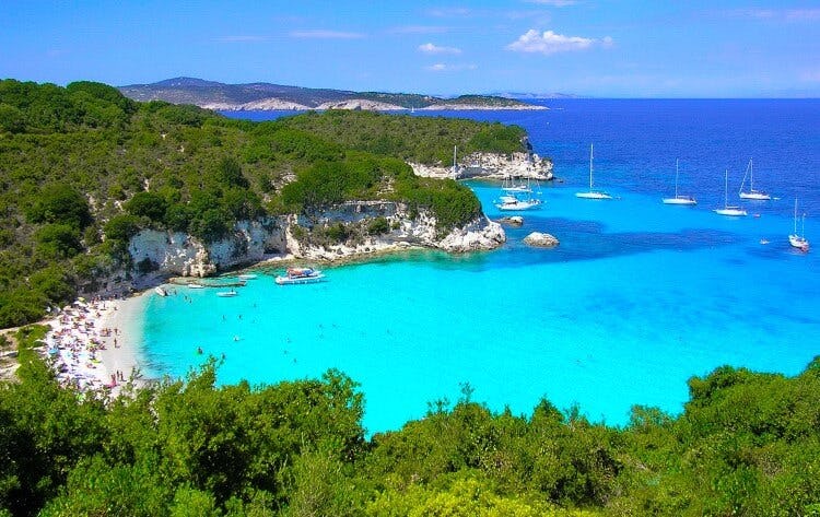A secluded bay with a strip of forest-backed white sand on Antipaxos island