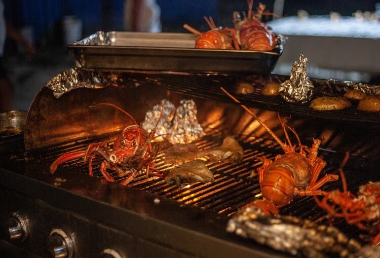 Lobsters being cooked on a BBQ