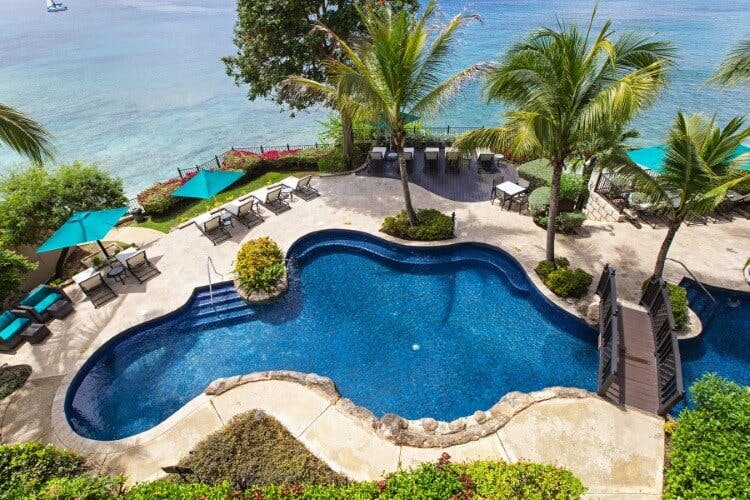 Sandy Cove 301 vacation rental - ariel view of pool with sun loungers, palm trees, and ocean