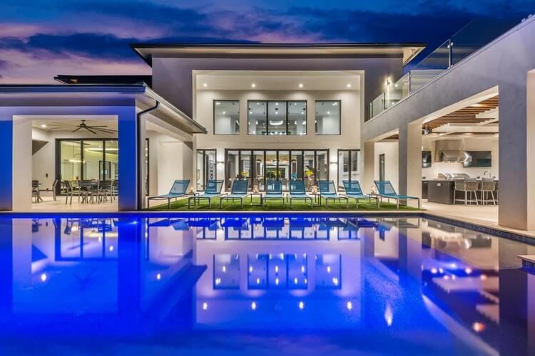 elegant large villa at dusk with pool