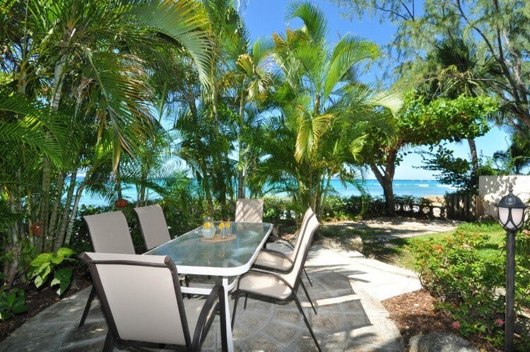outdoor dining set with sea in background