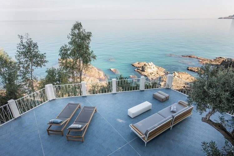 loungers overlooking rocks and ocean