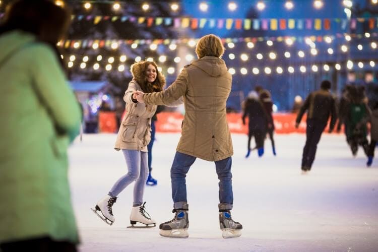 A man and a woman ice skating