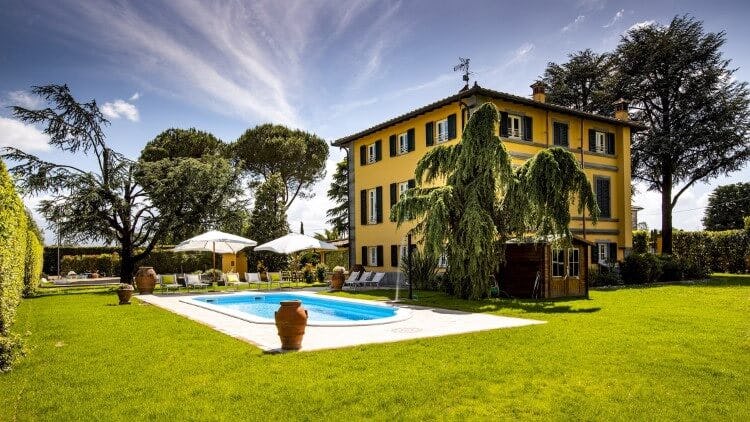 large yellow villa with pool