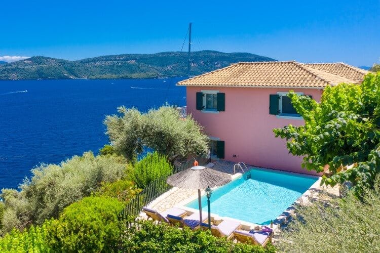 pink villa with pool overlooking sea