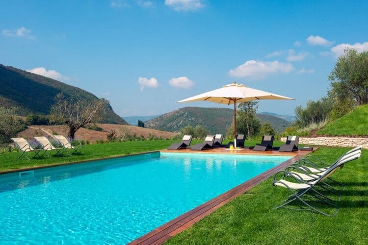 pool and loungers overlooking hills