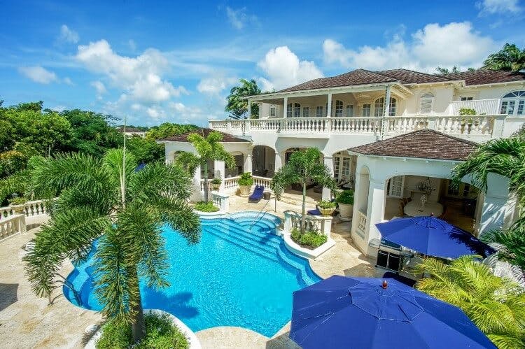 large white villa with shaped pool