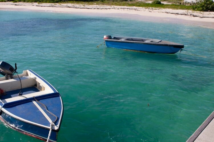 Two boats bobbing in the clear blue water at Harbor Island, Anguilla
