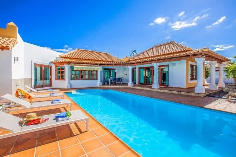 white and orange villa with pool
