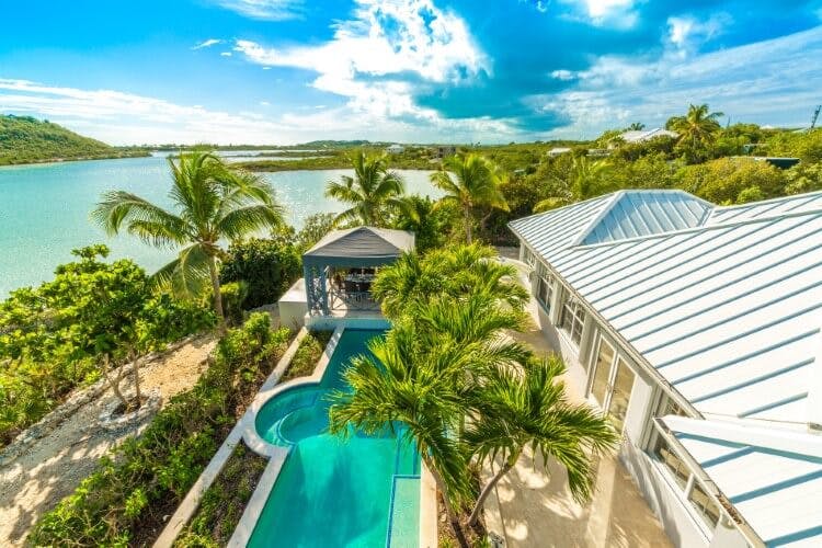 aerial view of vacation rental with pool and water
