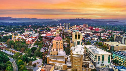 Ariel view of the buildings in Asheville, North Carolina at sunset