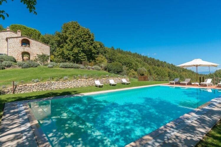 pool with stone villa on slope