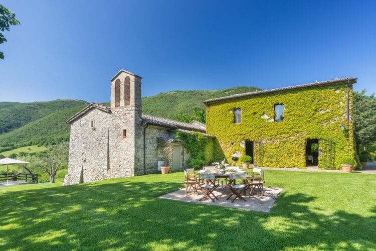 rustic stone villa surrounded by greenery