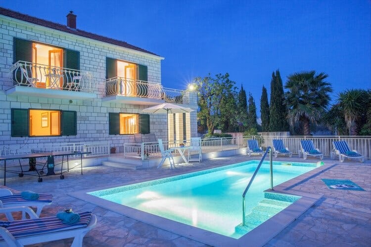 white villa and pool at dusk