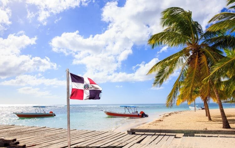Dominica Republic flag on a beach
