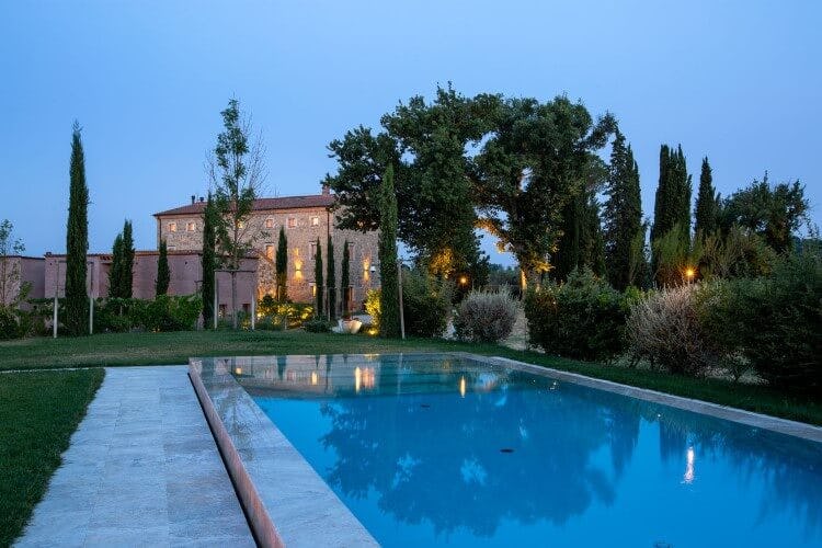 rustic villa and pool at dusk