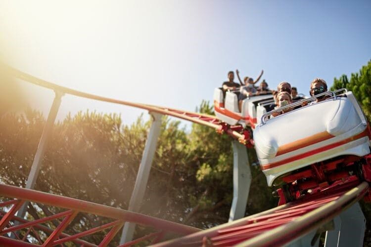 People riding in a roller coaster car