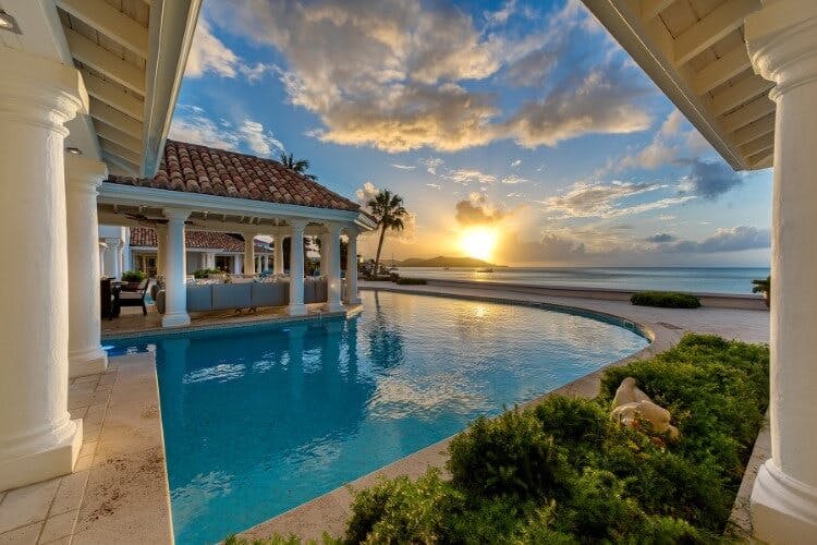 Petit Plage 5 vacation rental pool overlooking the Caribbean Sea at sunset