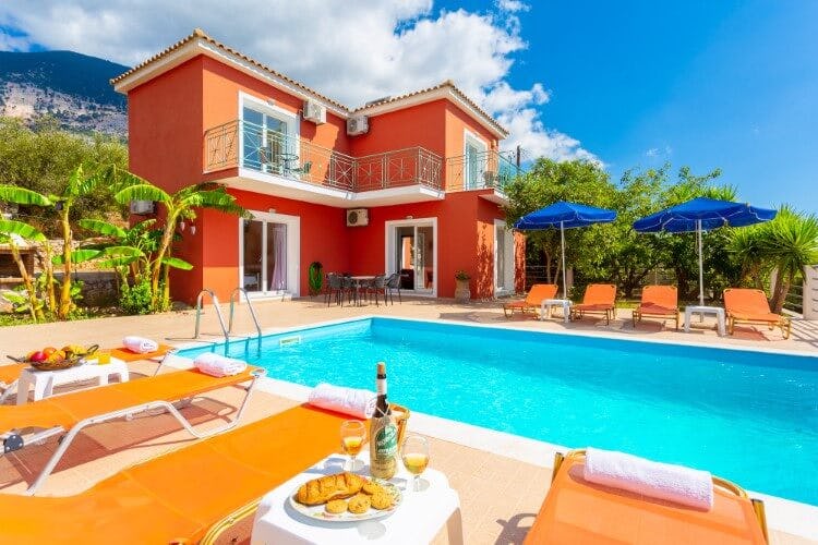 bright orange villa with orange loungers and pool