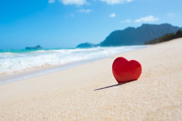 A heart-shaped rock on a beach