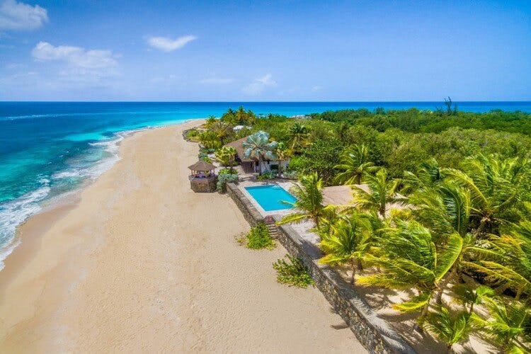 aerial image of beach with vacation rental with pool