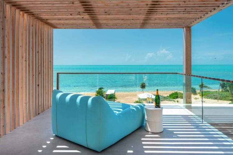 blue chair on balcony overlooking ocean