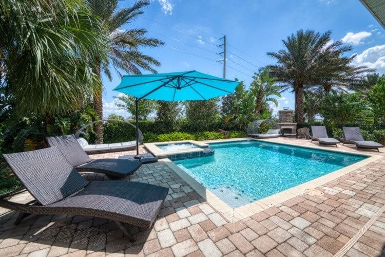outdoor area with parasol, hot tub, loungers and pool