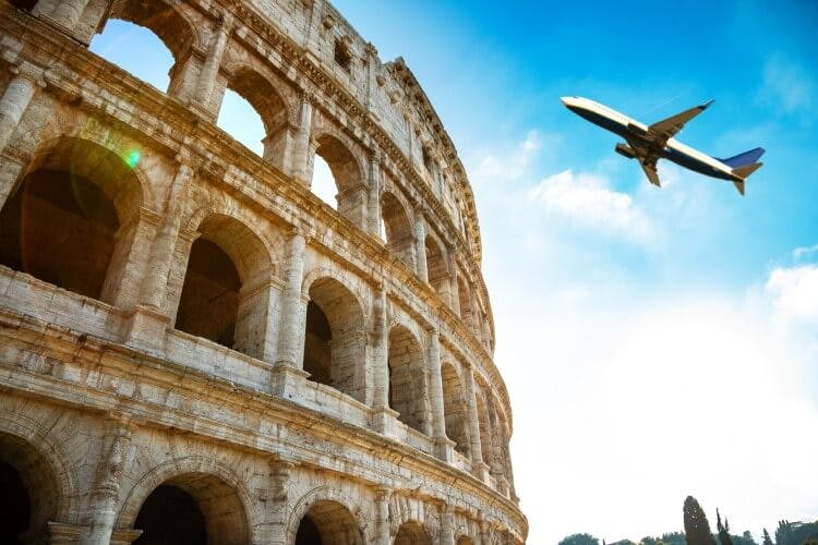 A plane flying over the Colosseum in Rome