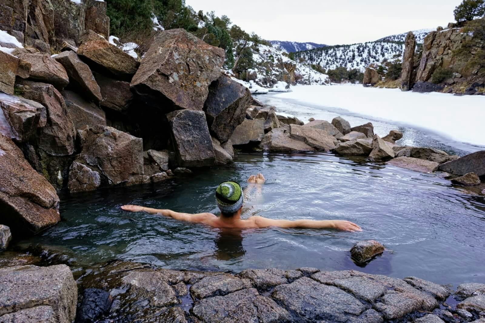A man relaxing in natural hot springs in Colorado