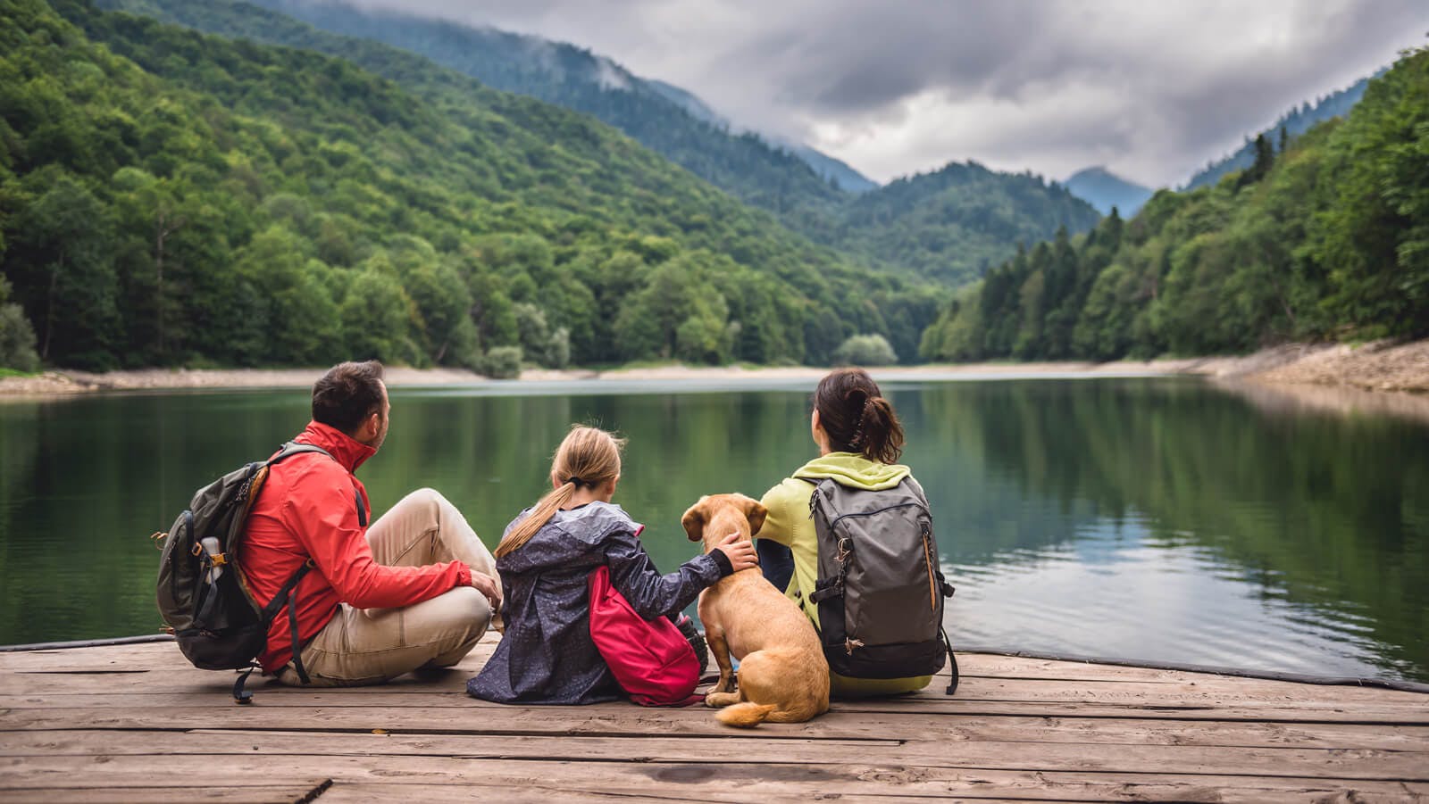 pet friendly travel family by lake with dog