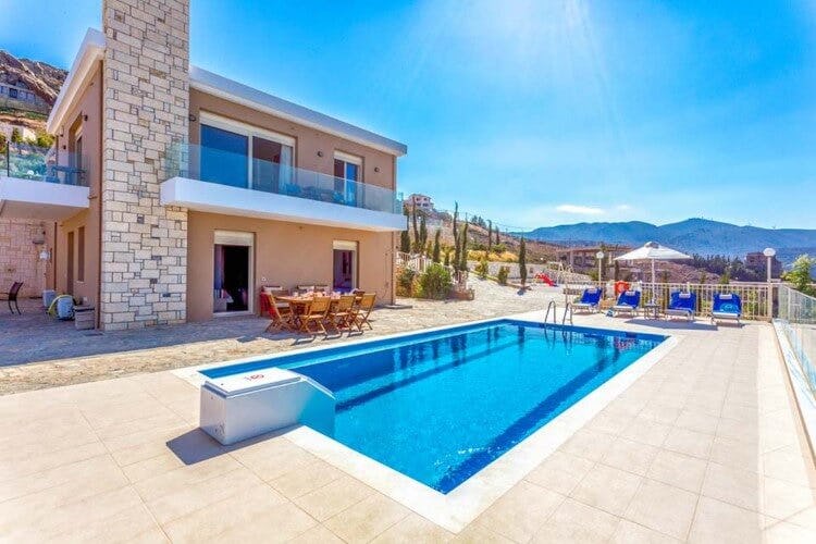 villa with pool and seating area