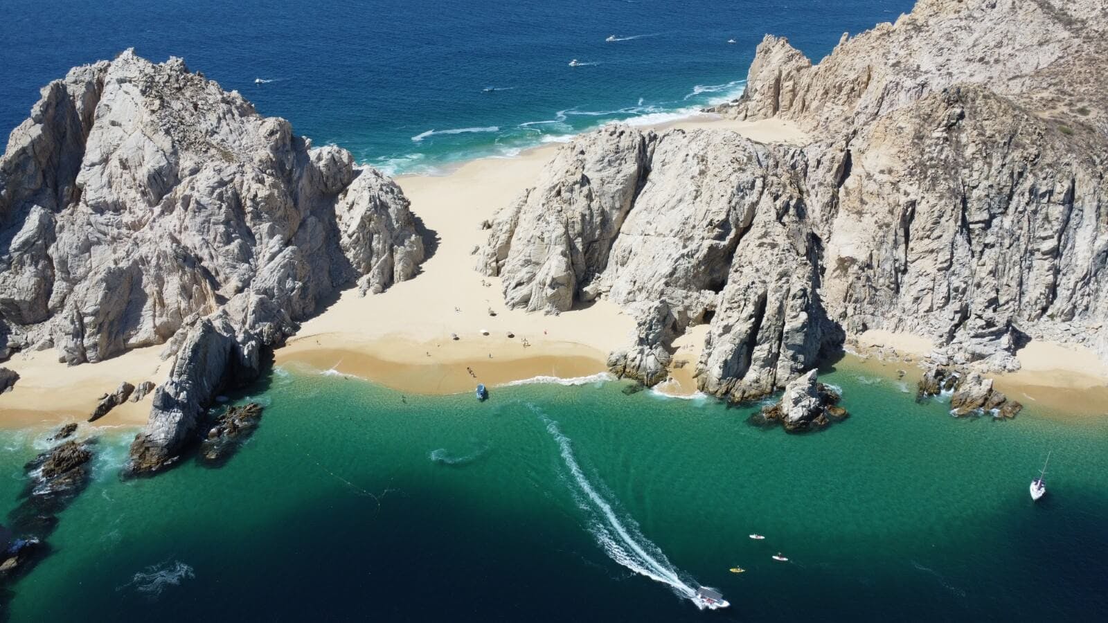 beach boats and cliff in cabo