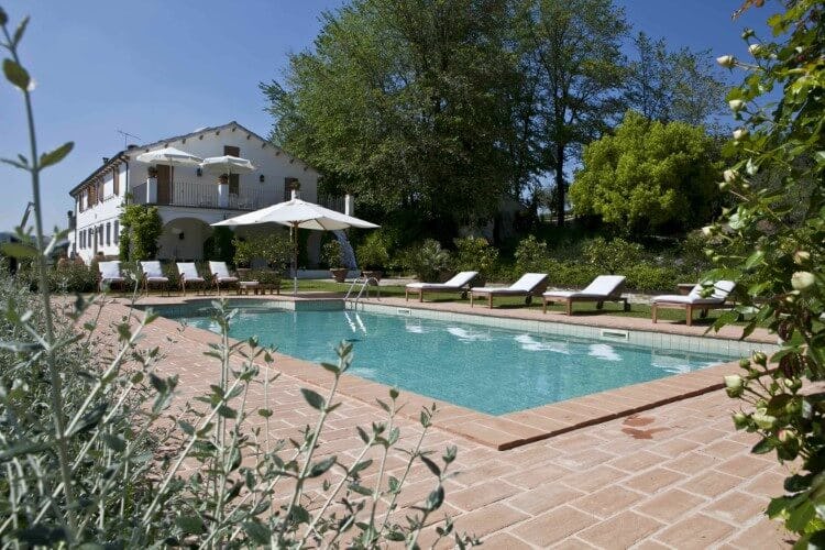 Villa La Picena in Le Marche Italy; a traditional farmhouse-style villa with a private pool and sun loungers