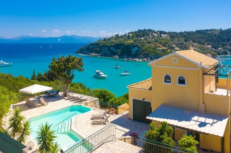 yellow villa with pool overlooking ocean