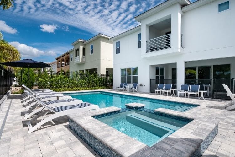white villa with pool, hot tub and loungers