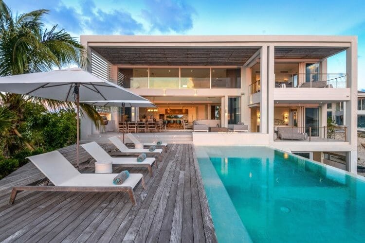 modern villa with pool, deck and loungers