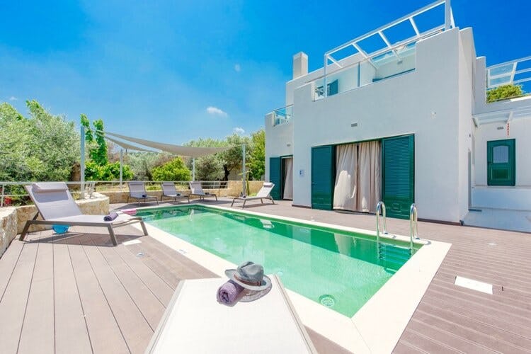 white villa with deck and pool