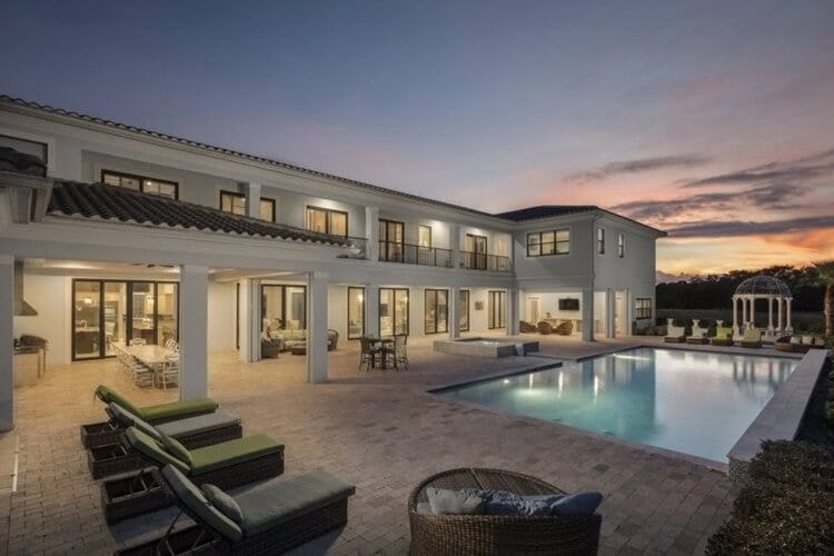 white villa and pool at dusk