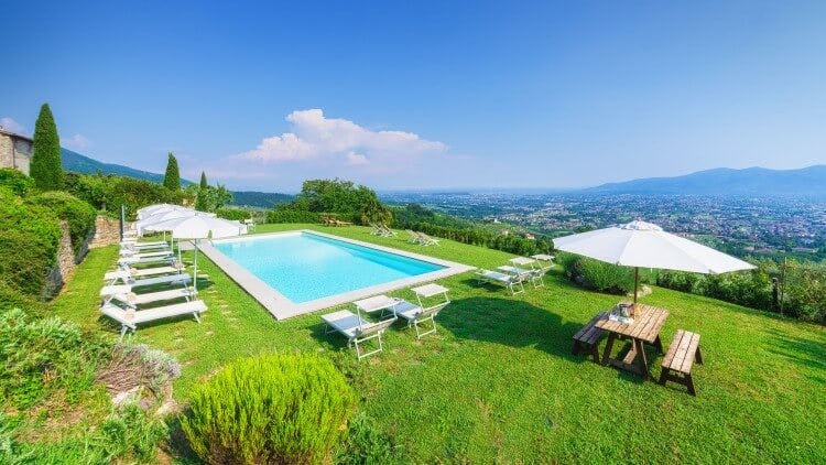 pool in lawn with view over tuscan countryside