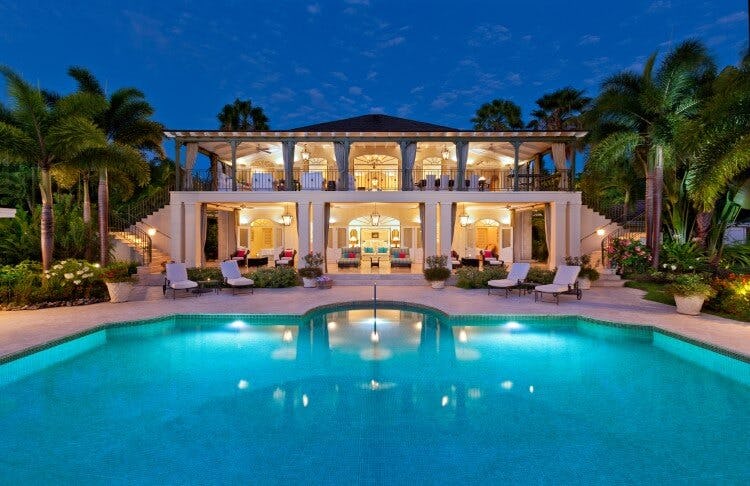 large villa with pool at dusk