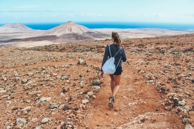 A woman walking amongst volcanoes in Fuerteventura