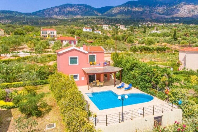aerial view of red villa with pool