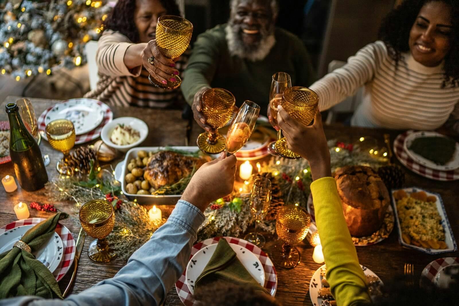 family toasting over christmas dinner