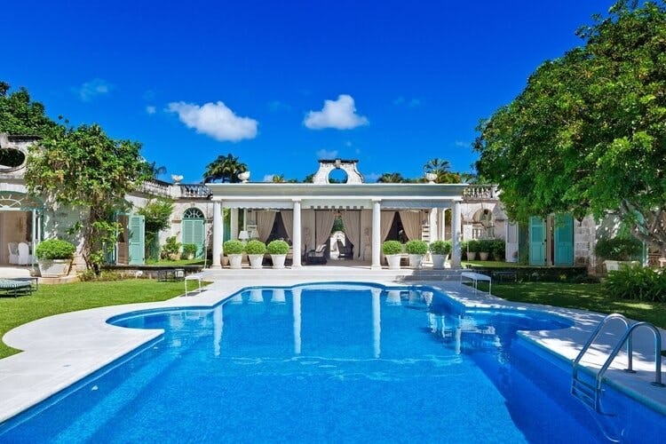 white villa with pool in foreground