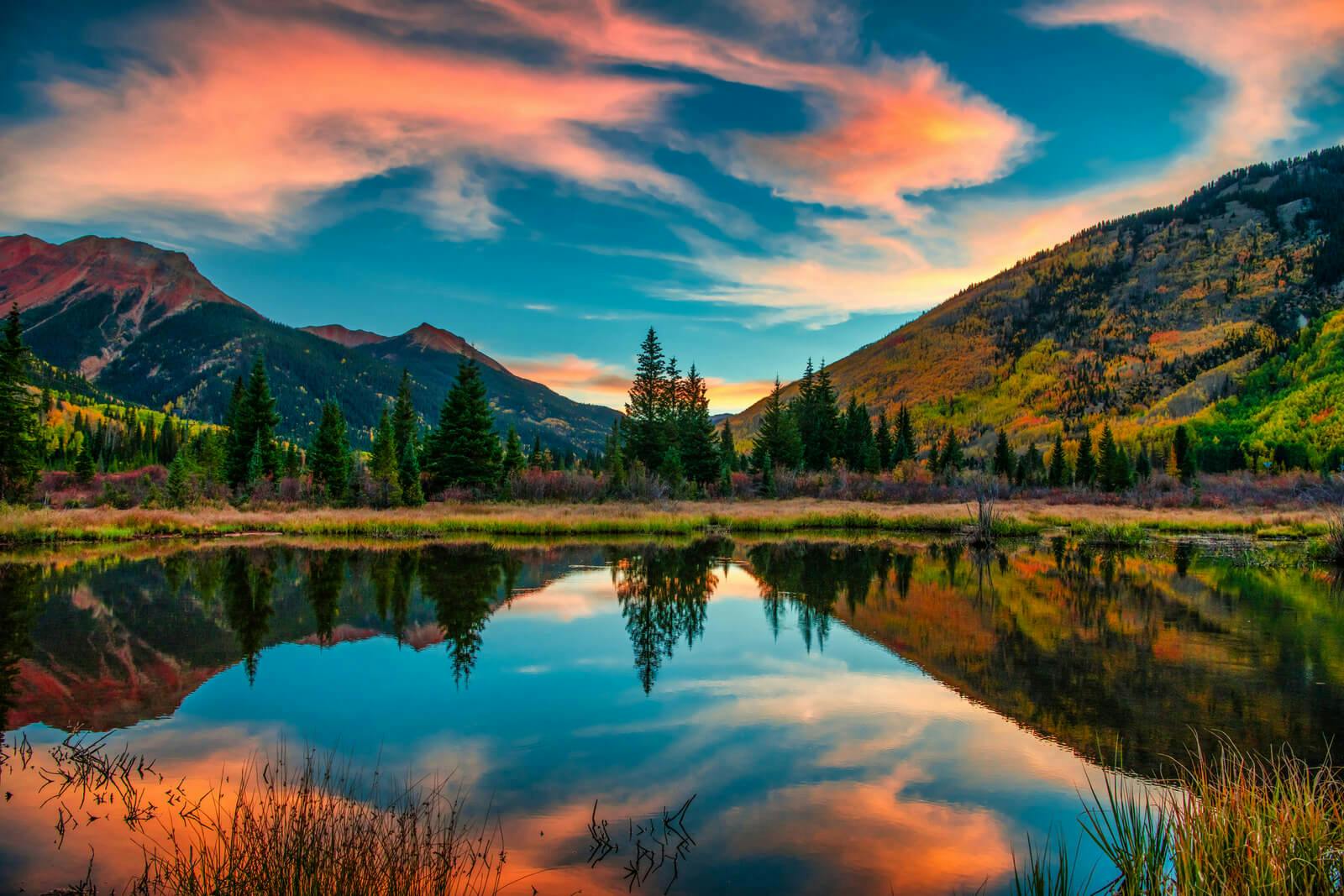 Rocky Mountains sunrise over a still lake